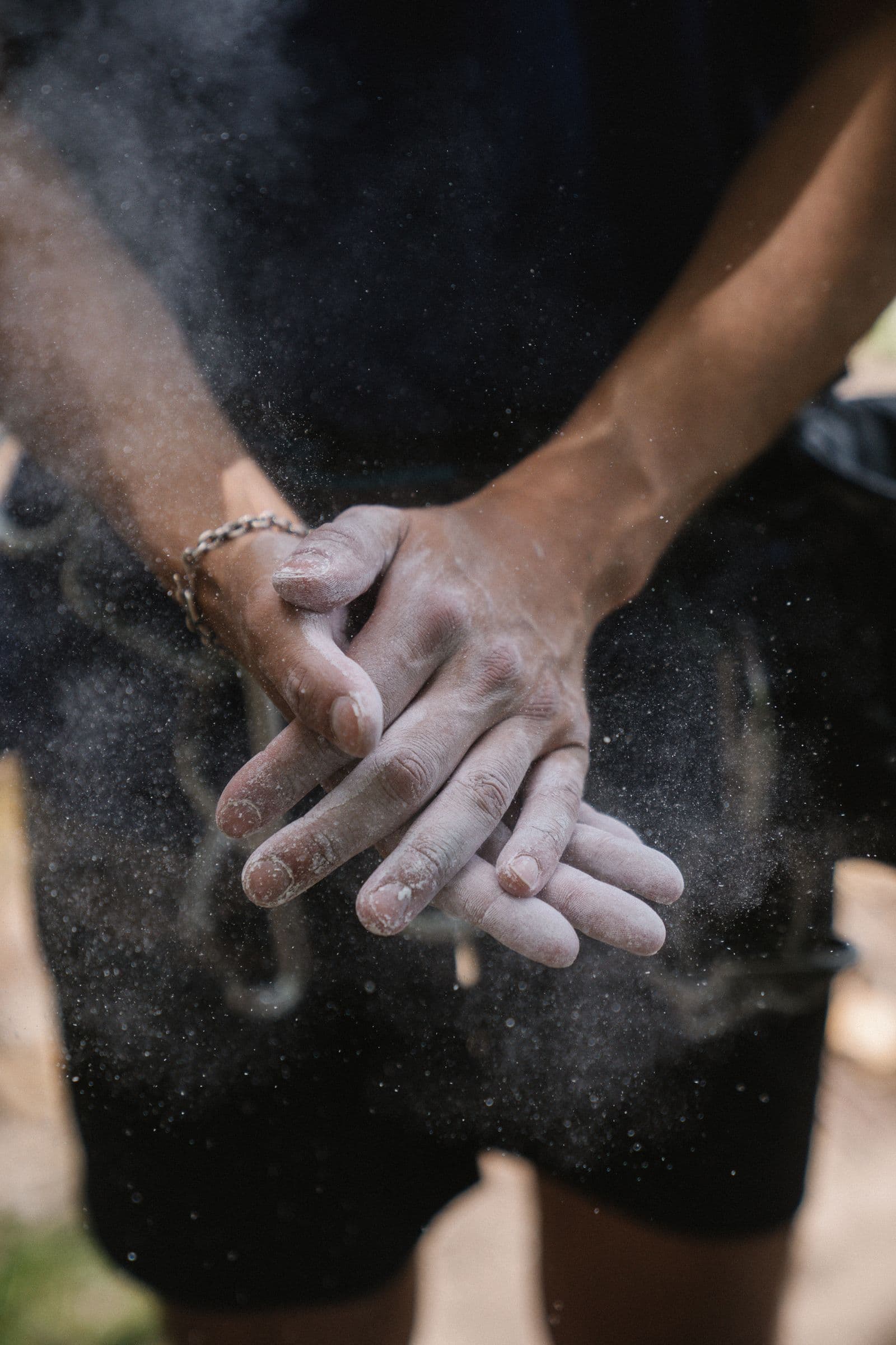 Climber clapping chalk from their hands