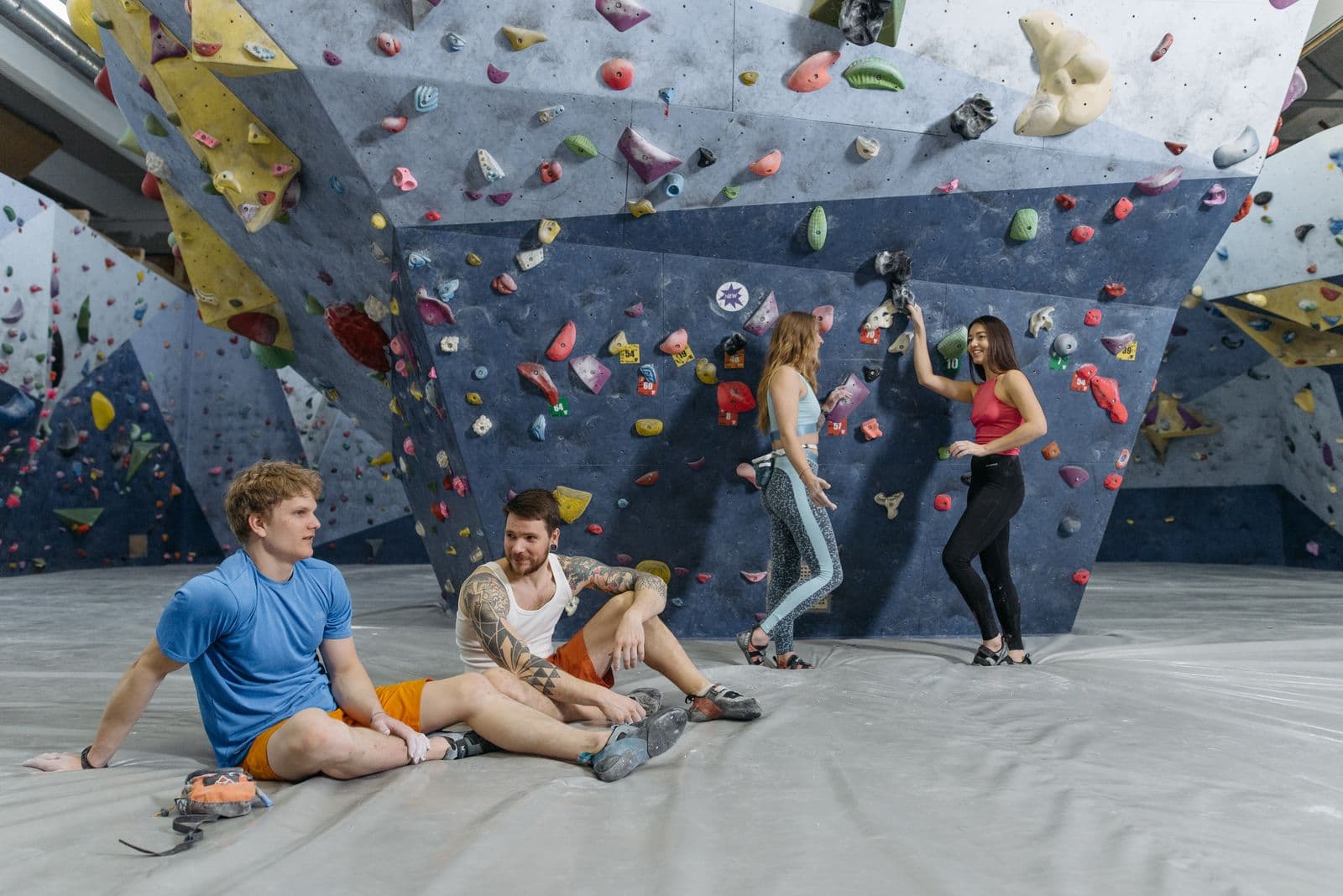 Climbers between attempts at an indoor bouldering gym