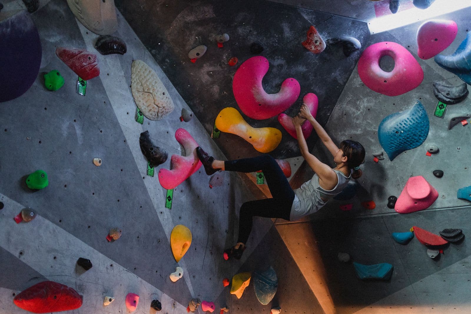 Climber working a difficult steep indoor wall