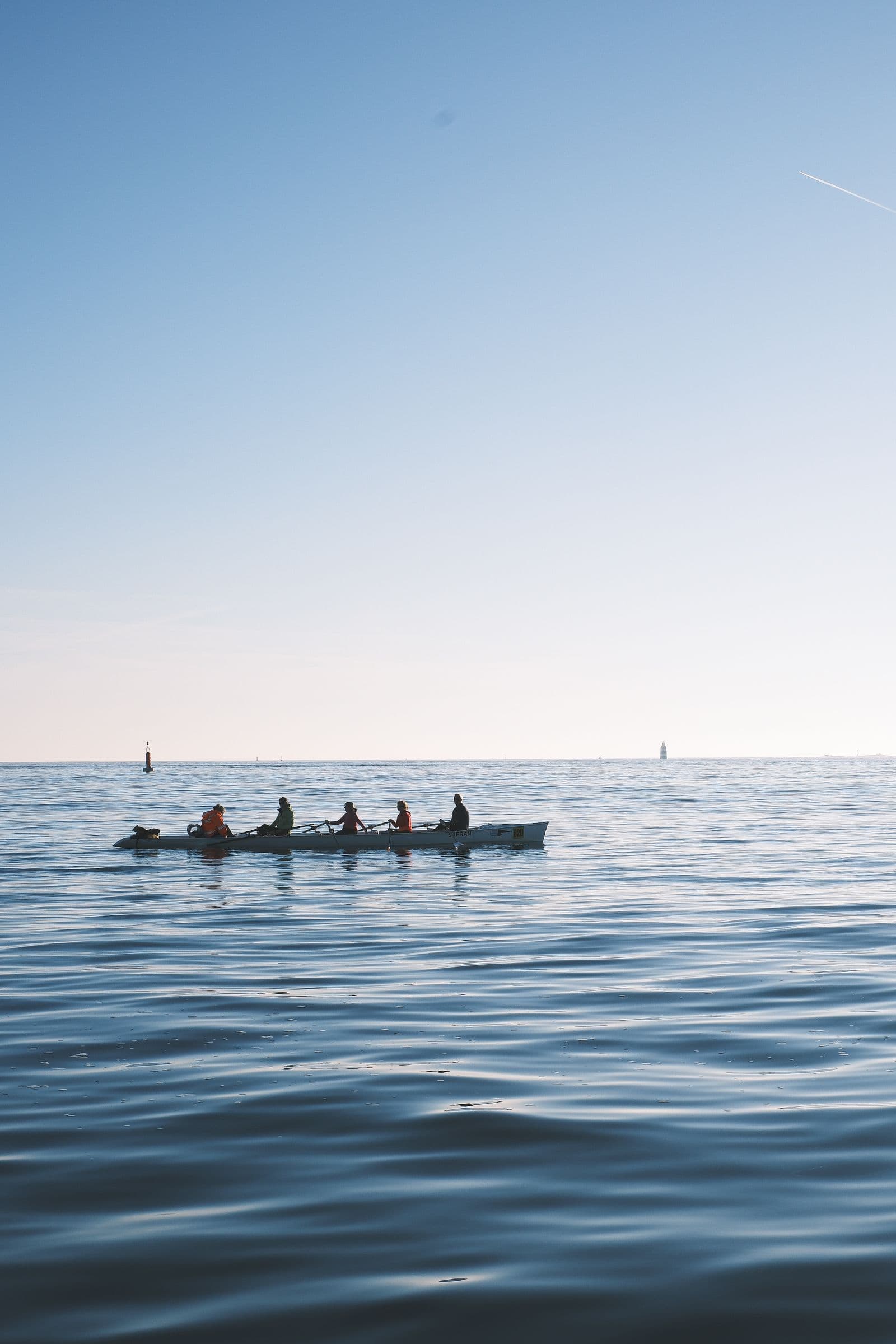 Crew rowing steady state on calm water