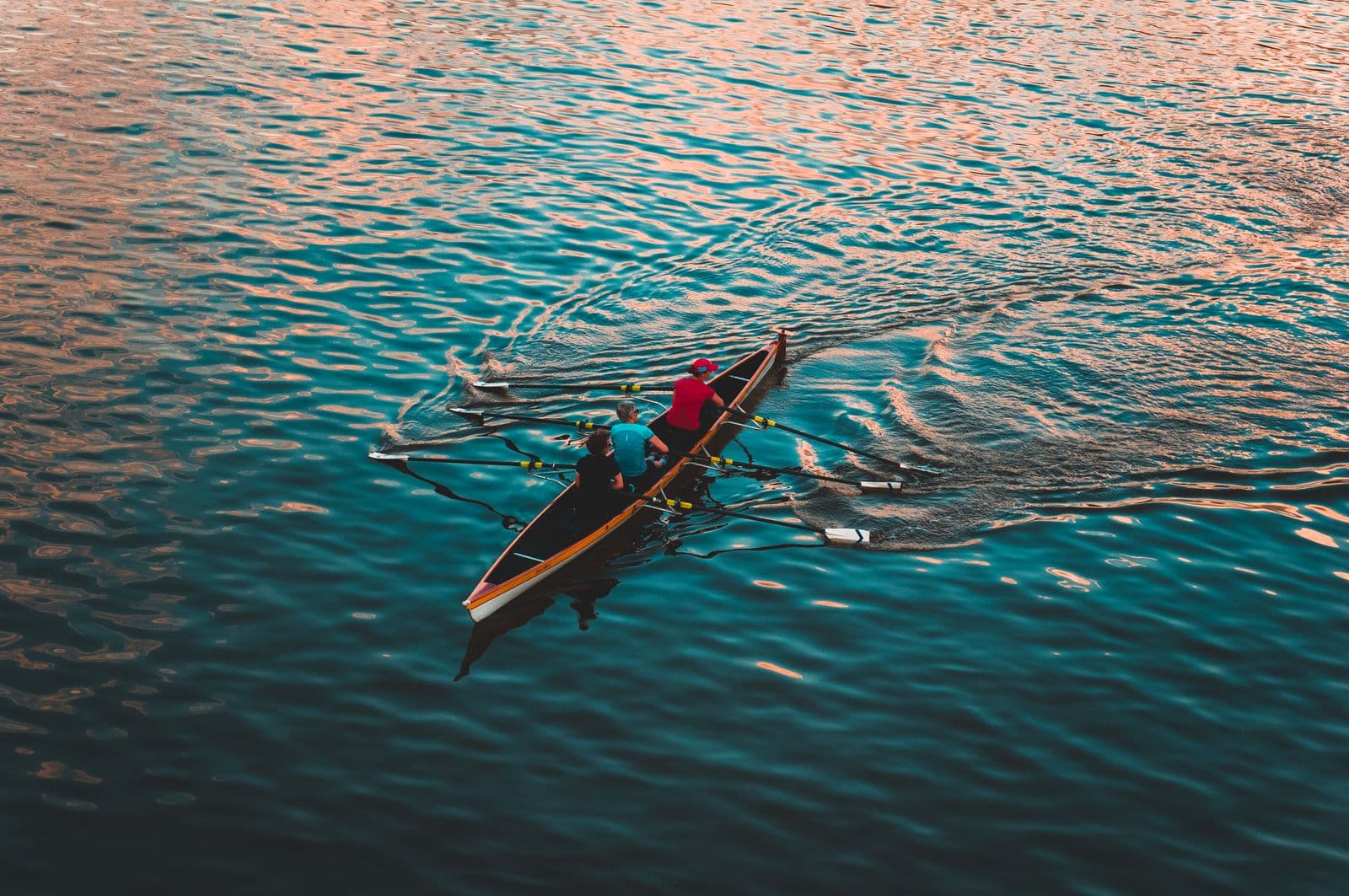 Crew rowing a shell across open water