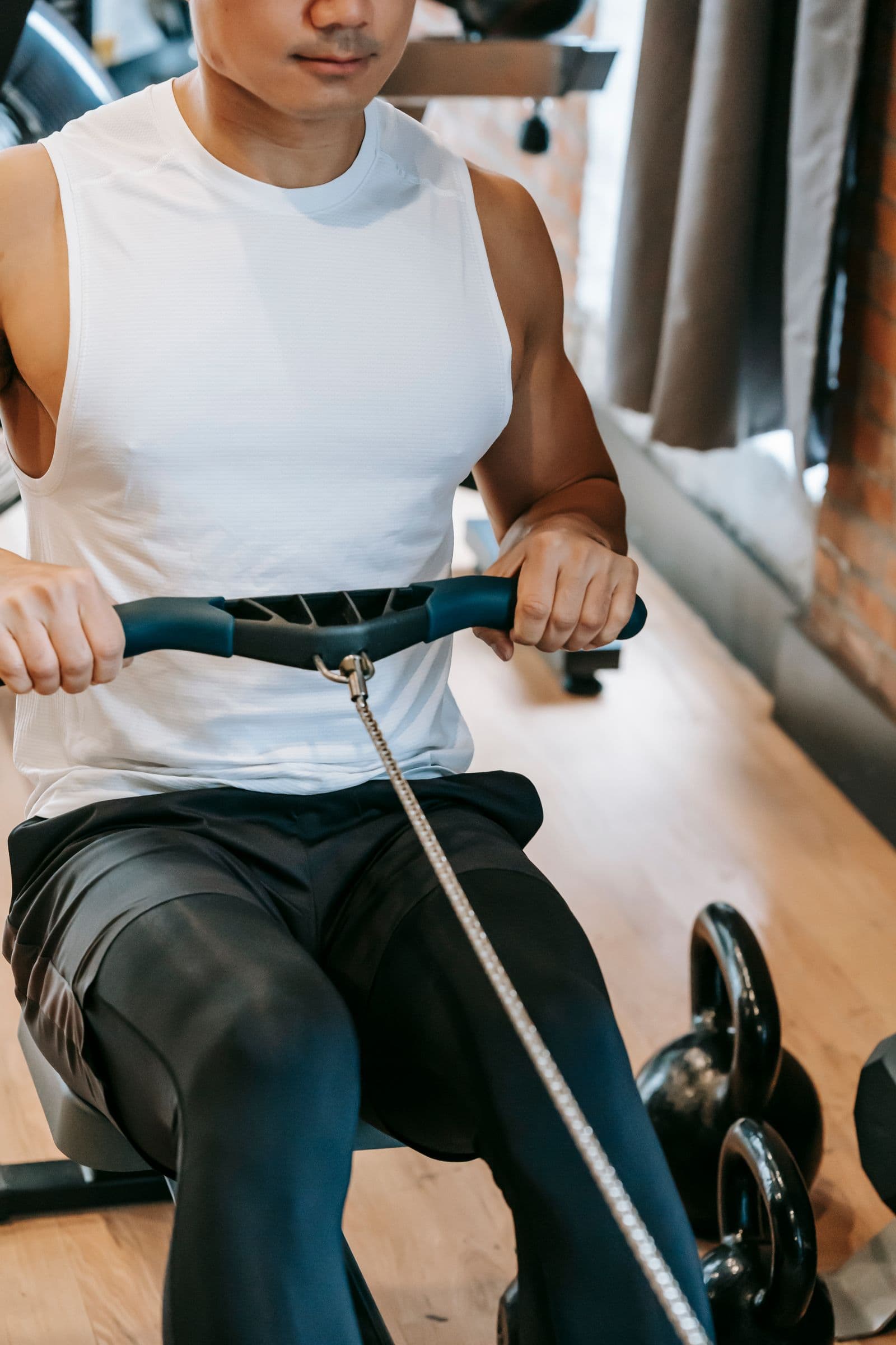 Athlete mid-drive on a rowing machine