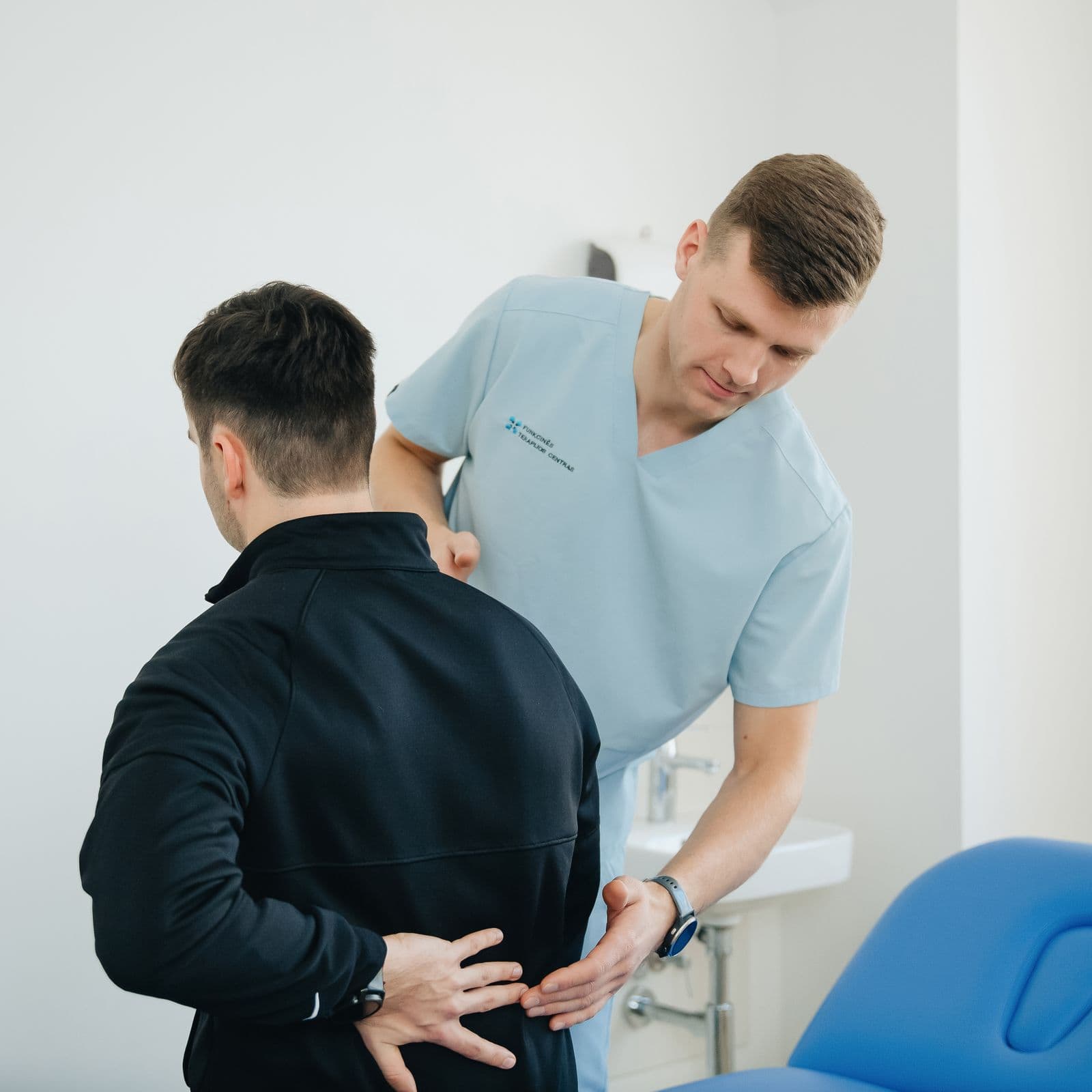 Clinician assessing a patient's back