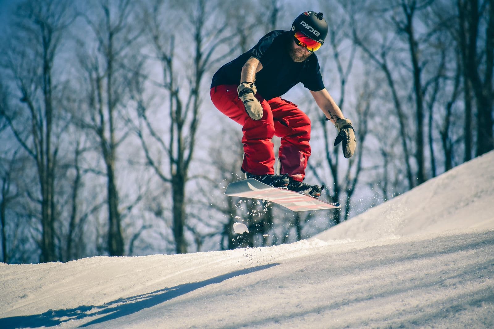 Snowboarder catching air on a snowy slope