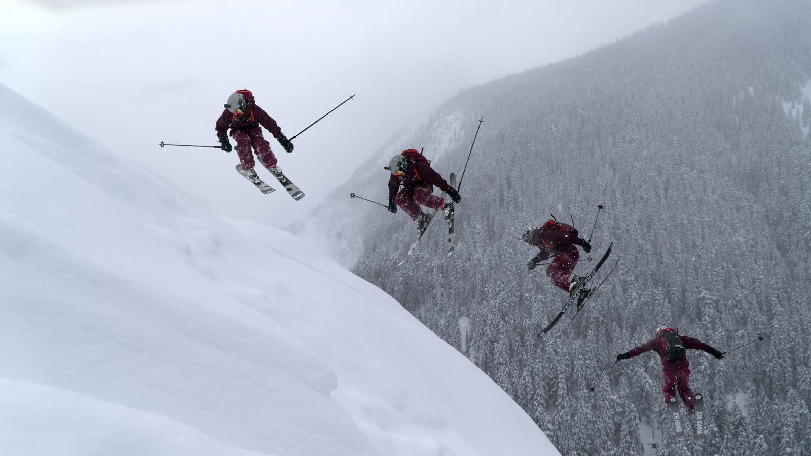 Skier mid-jump off a snowy mountainside