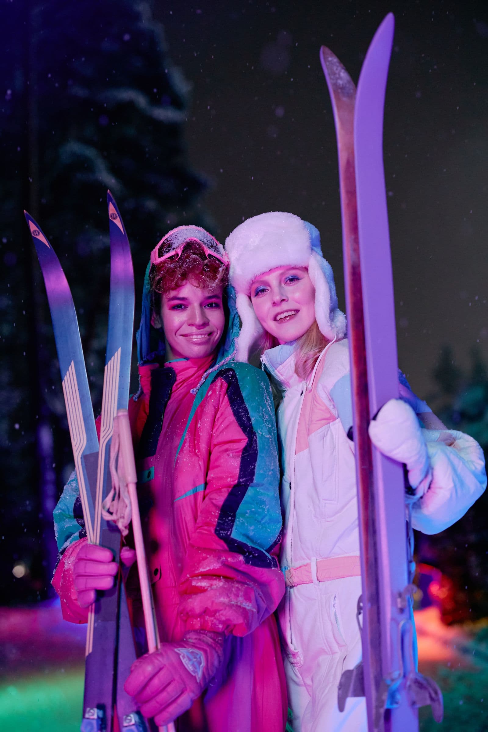 Two skiers under night-skiing lights