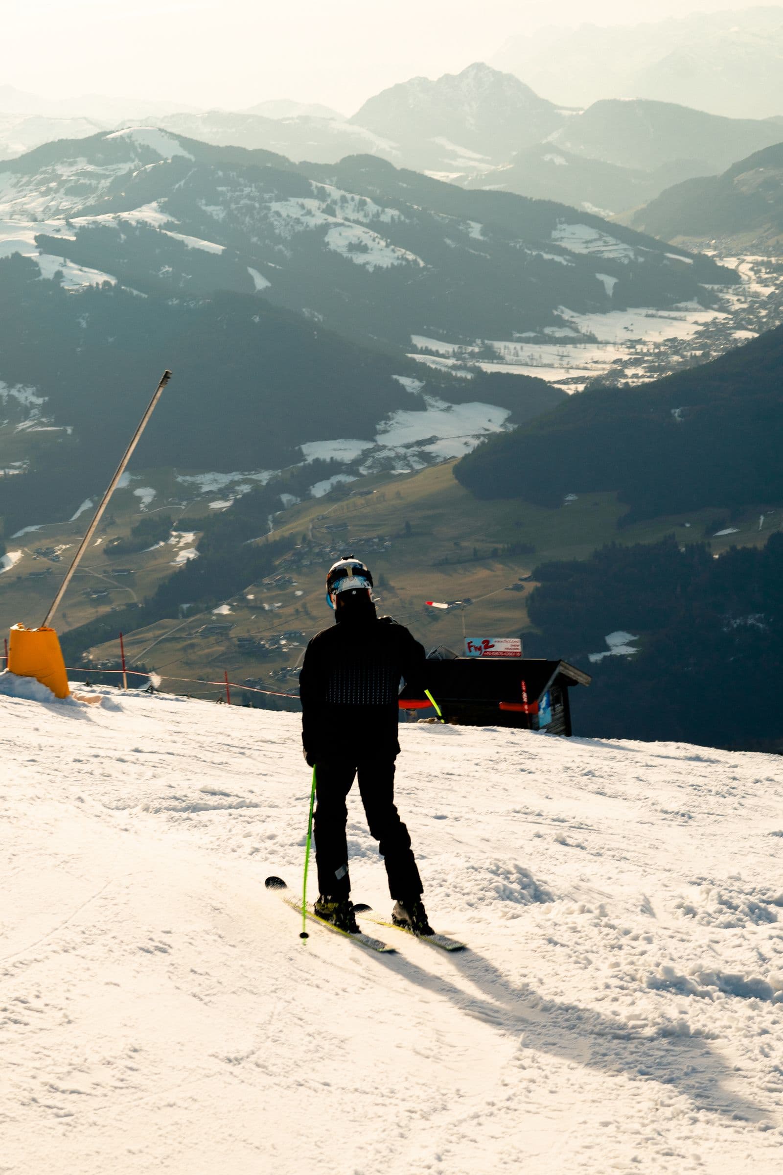 Skier on a mountain slope at sunrise