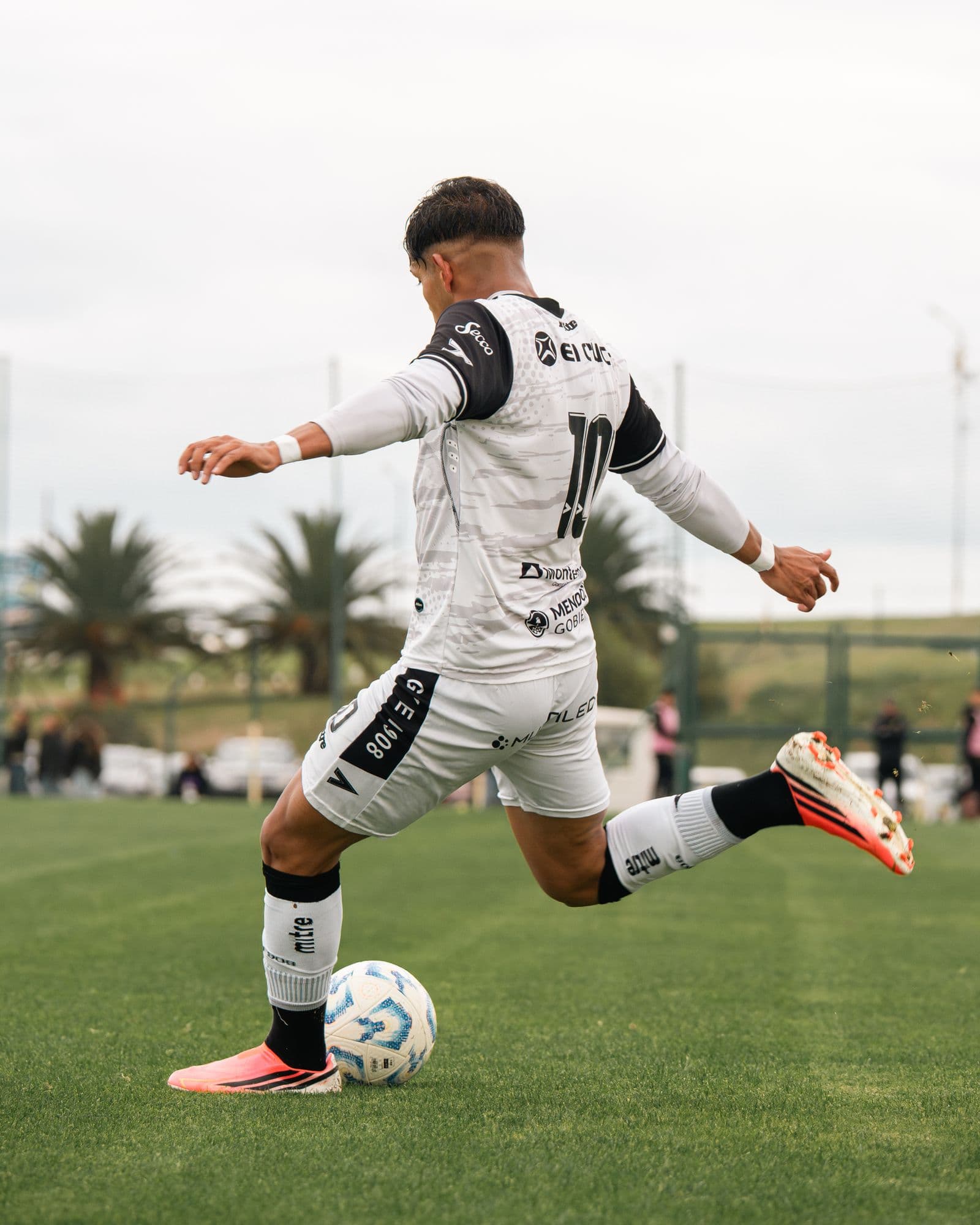Soccer player striking the ball mid-kick