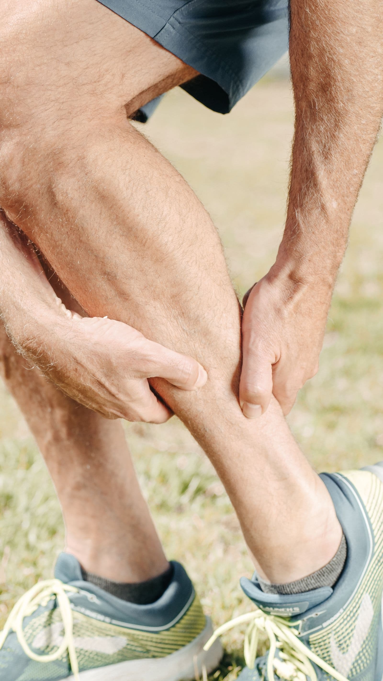 Athlete holding their calf during sport