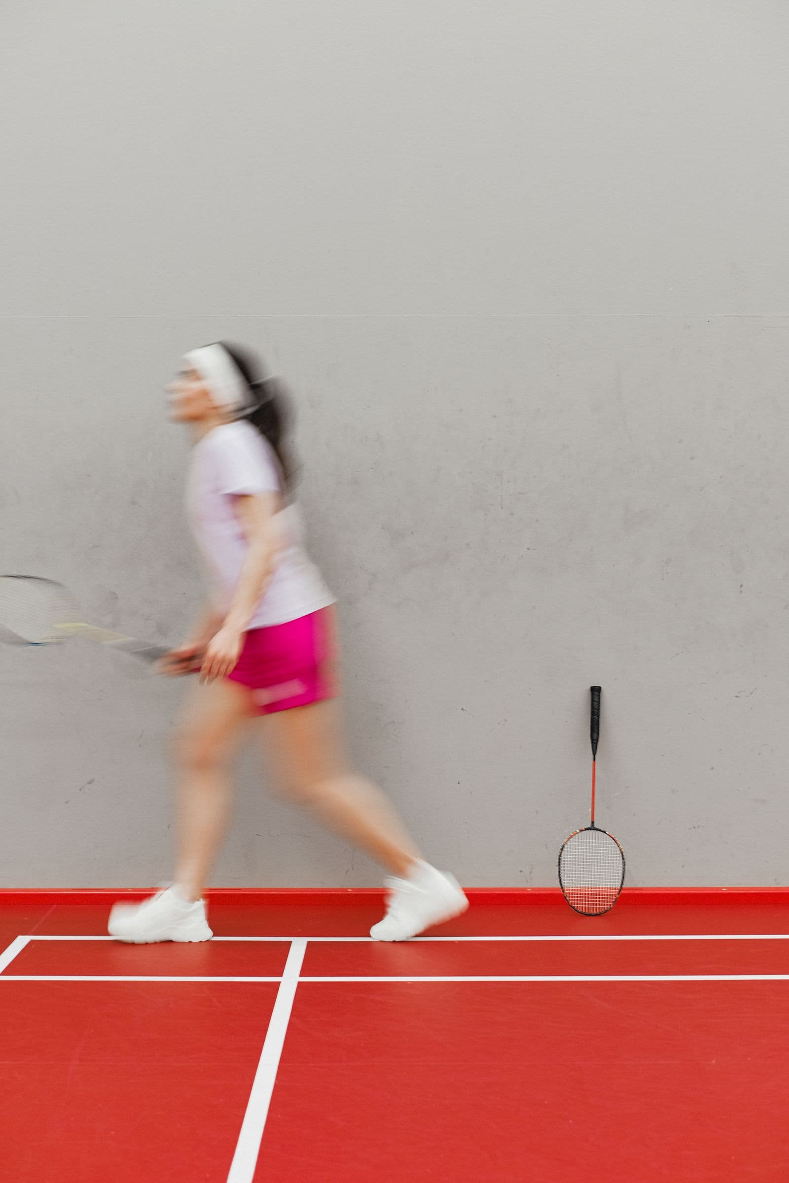 Badminton player in motion on an indoor court