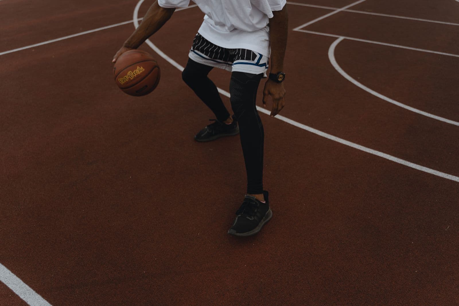 Player dribbling hard on an outdoor court