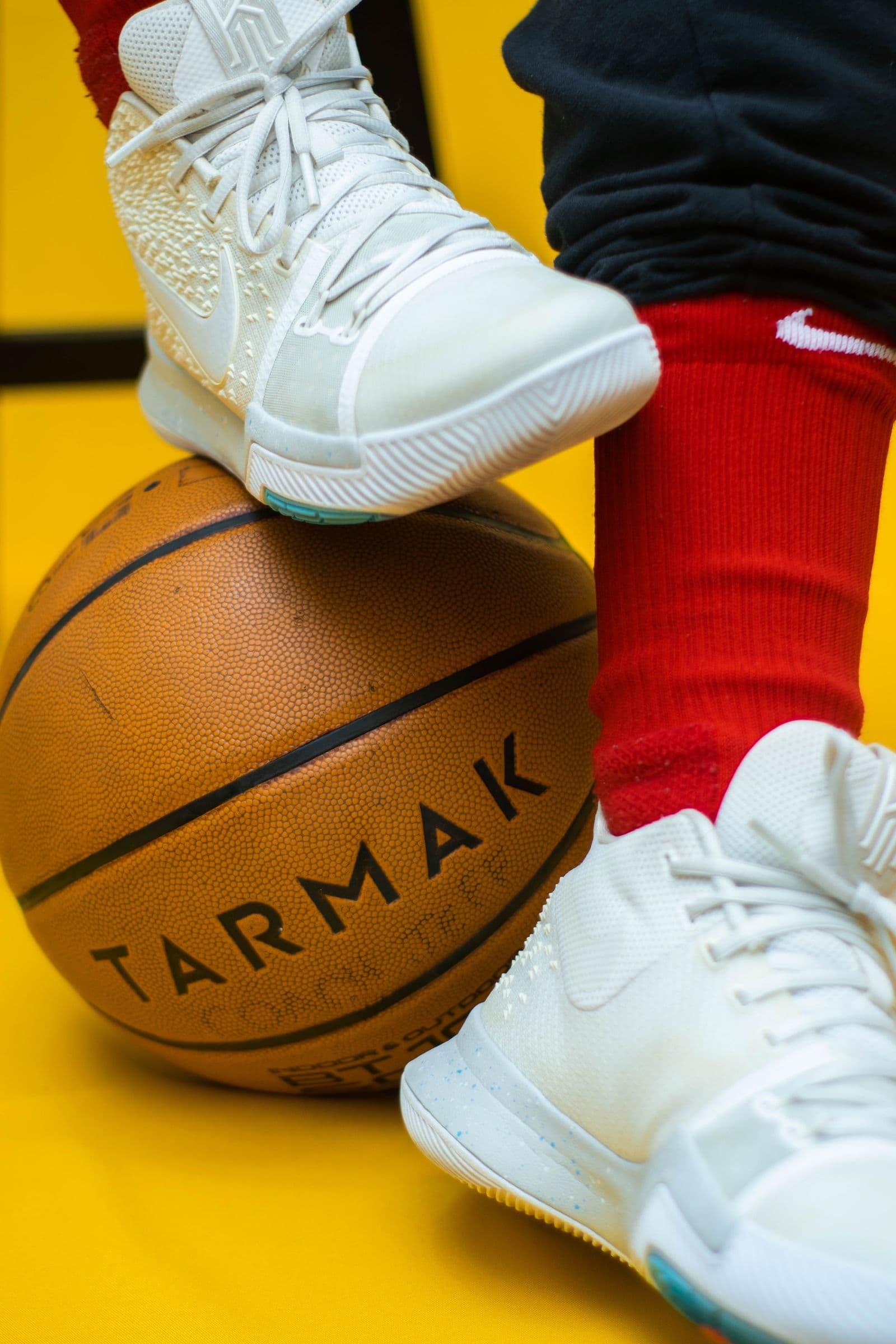 Player's shoe resting on a basketball courtside