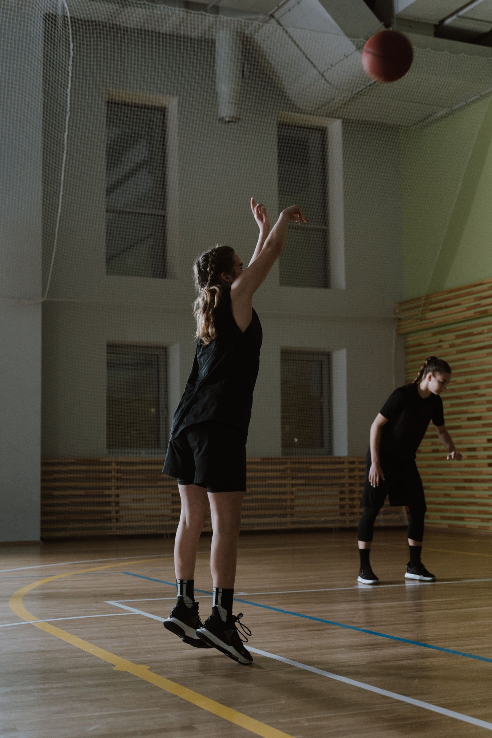 Player practicing shooting form in an indoor gym