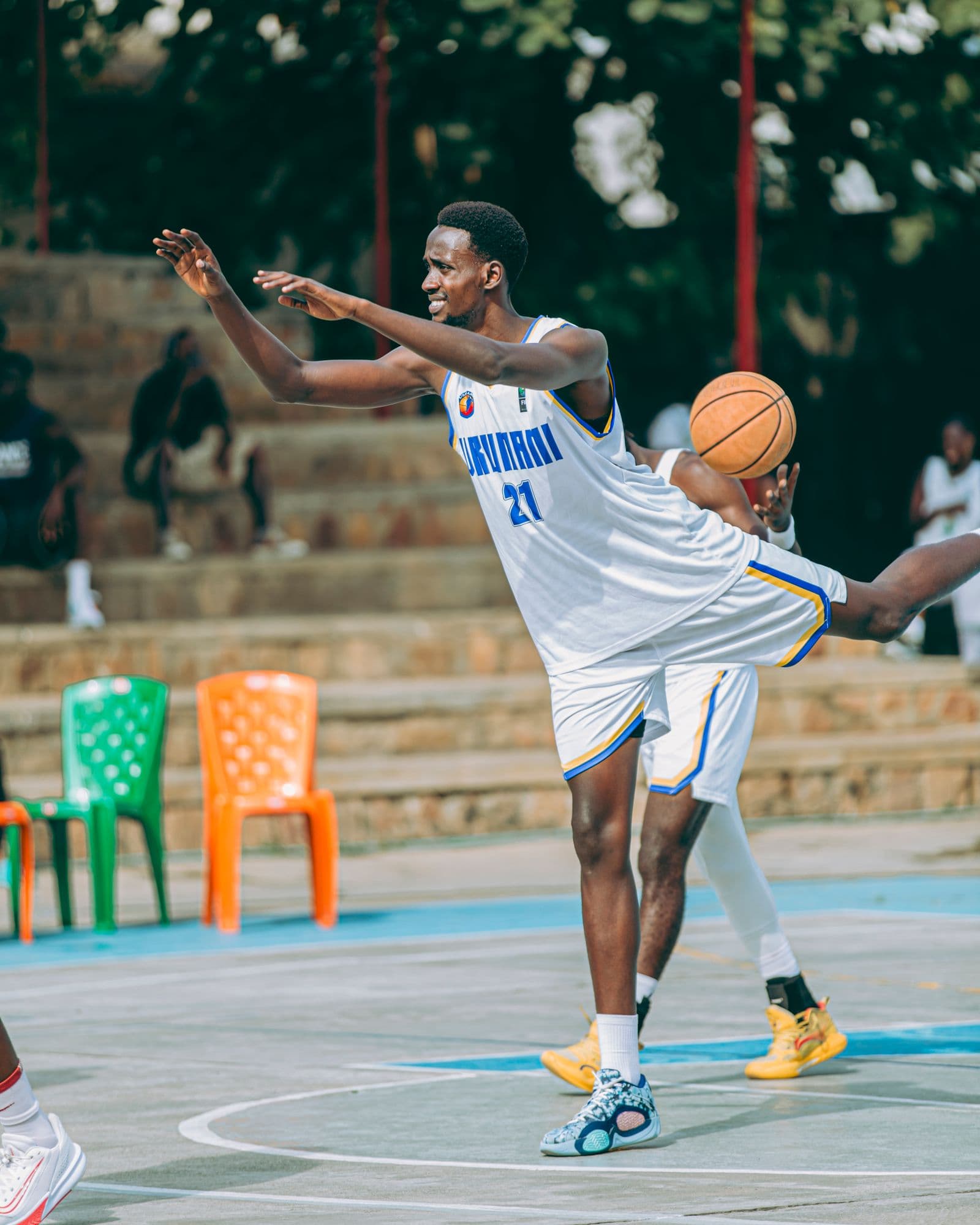 Players in a fast-paced outdoor basketball game