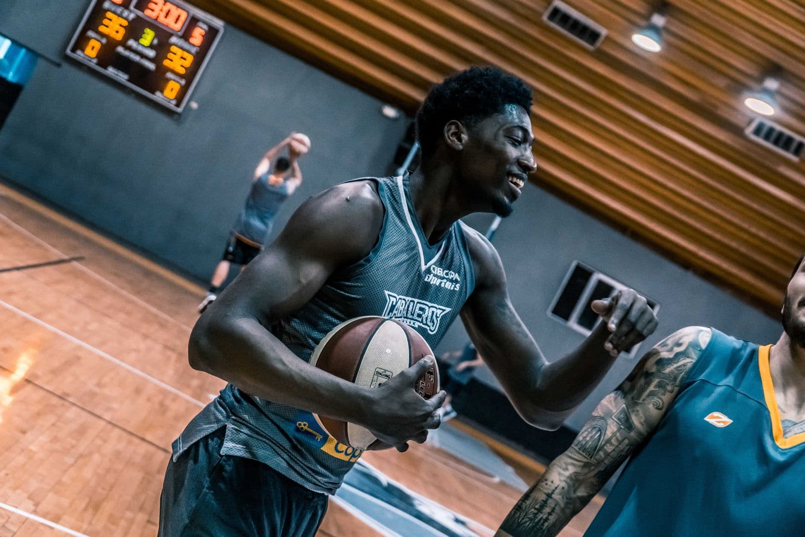 Basketball players' hands on the ball during indoor training
