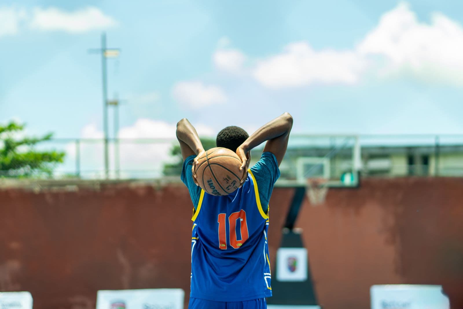 Young player lining up a shot on an outdoor court