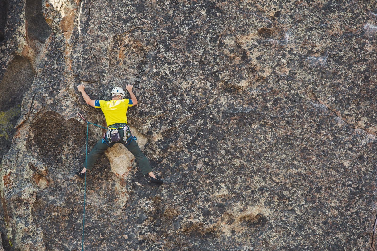 Climber in a helmet on an outdoor rock face