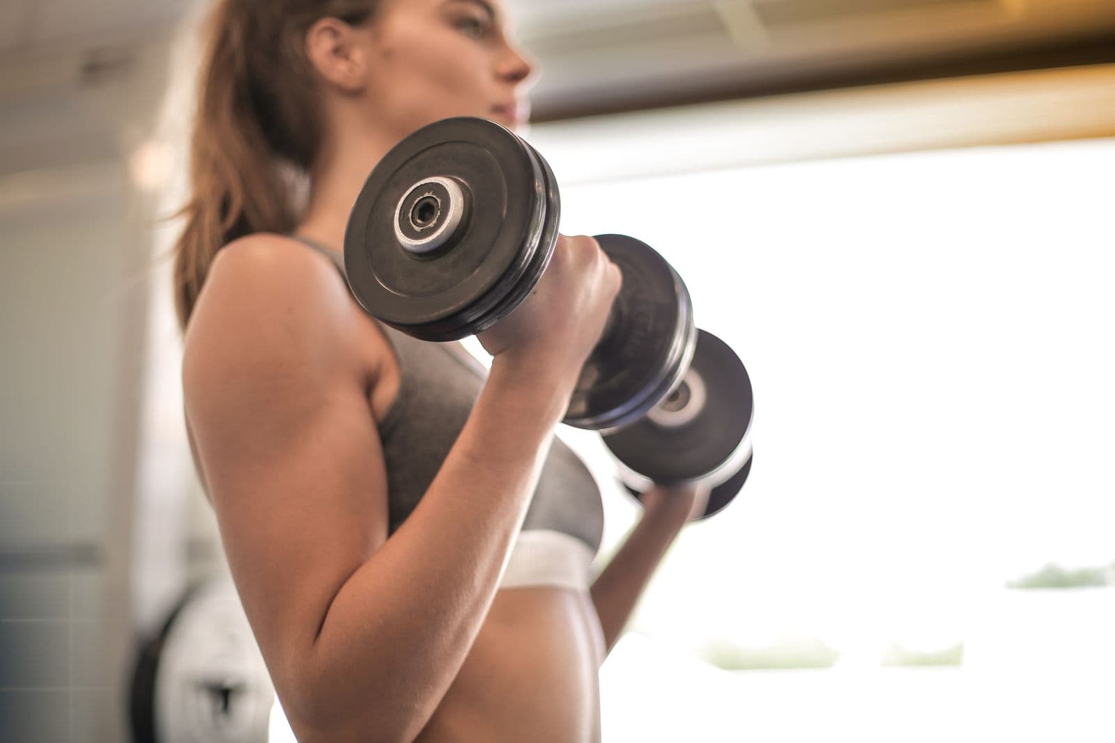 Athlete doing dumbbell strength work in a gym