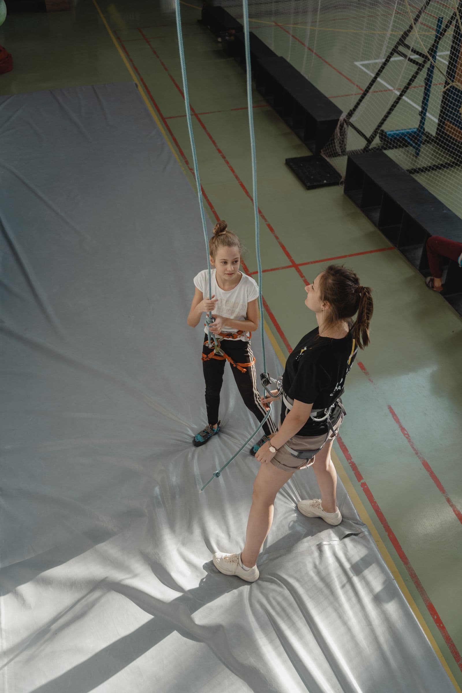 Young climber getting a roped lesson from an instructor