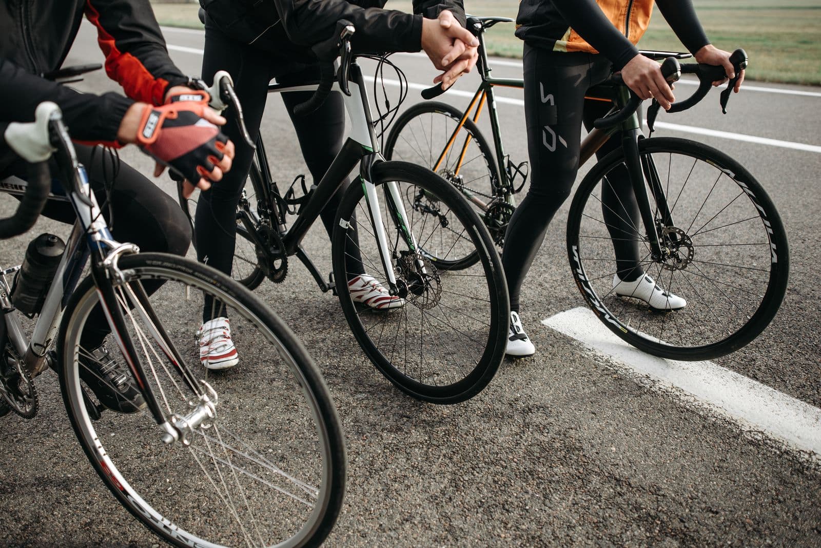 Close-up of road bikes lined up before a ride