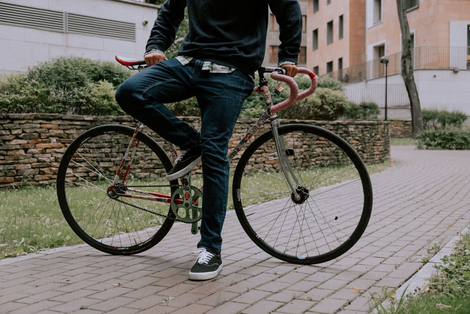 Rider standing beside a bicycle
