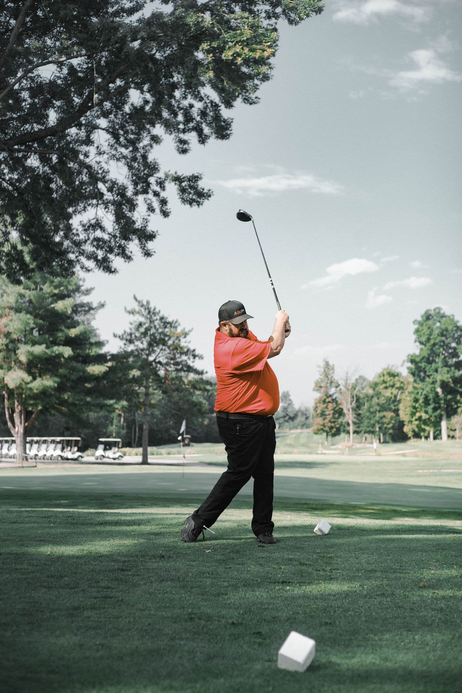 Golfer swinging a club on a sunny course