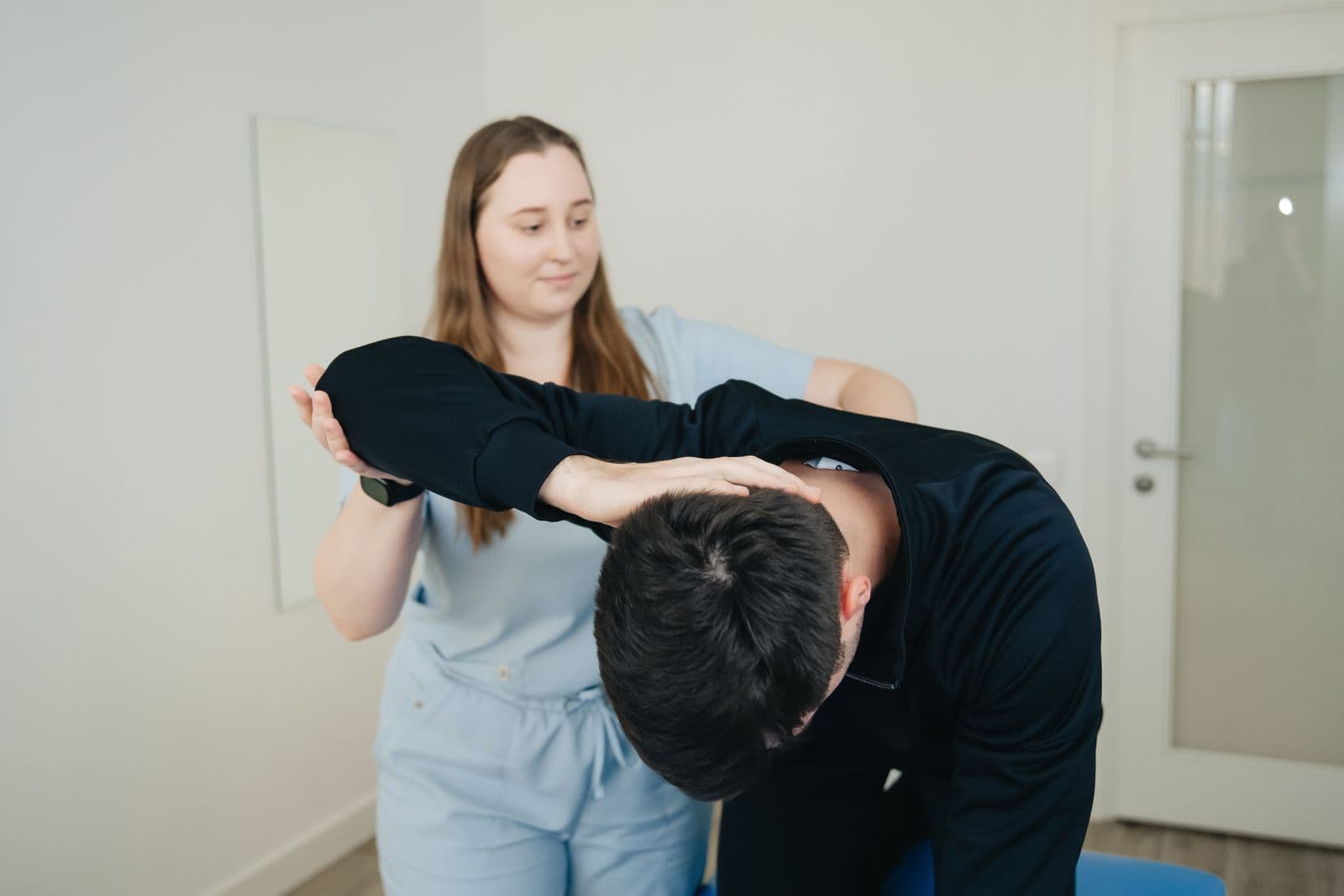 Clinician assessing a patient's back and trunk rotation