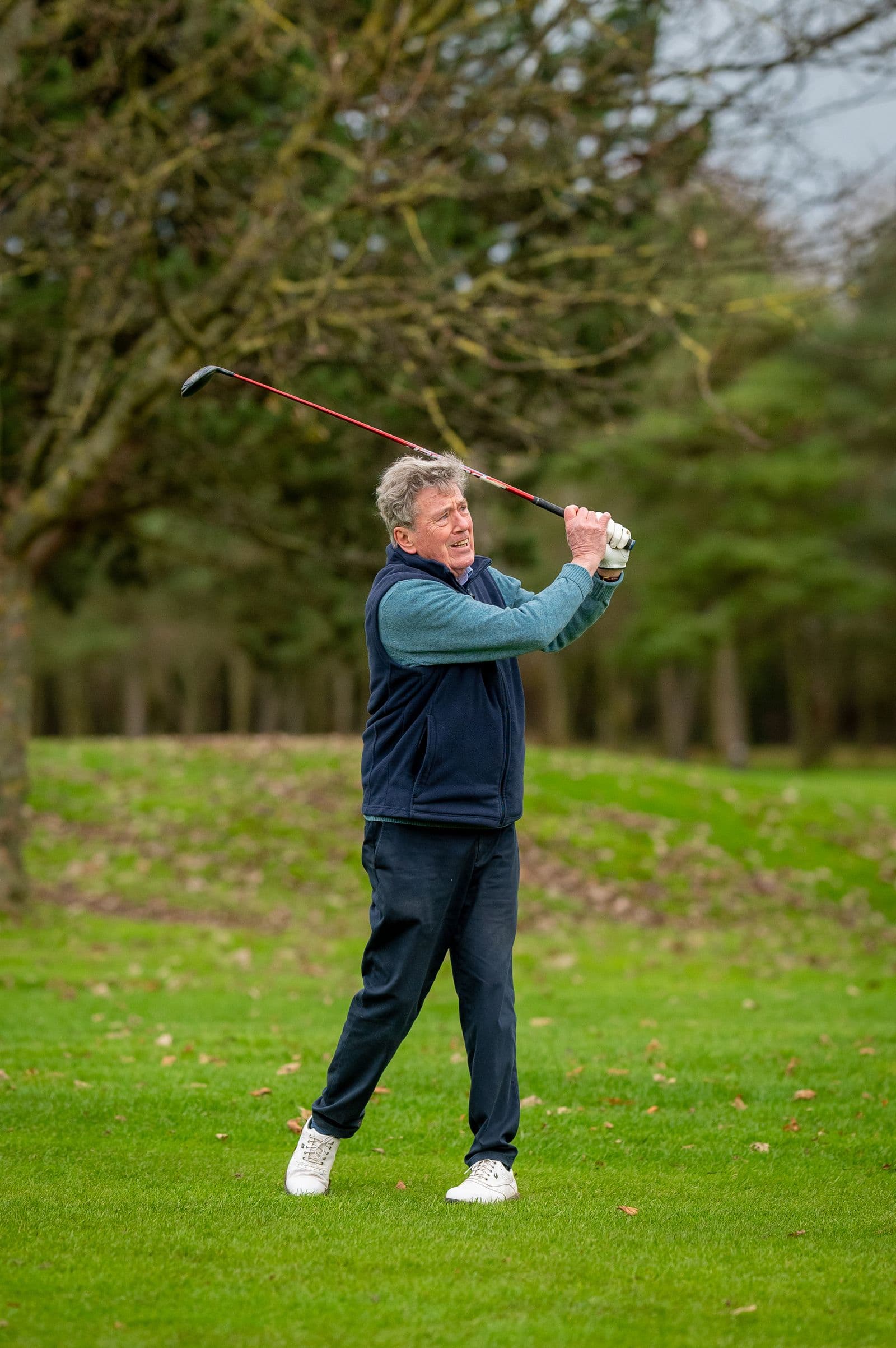 Older adult enjoying a golf swing outdoors