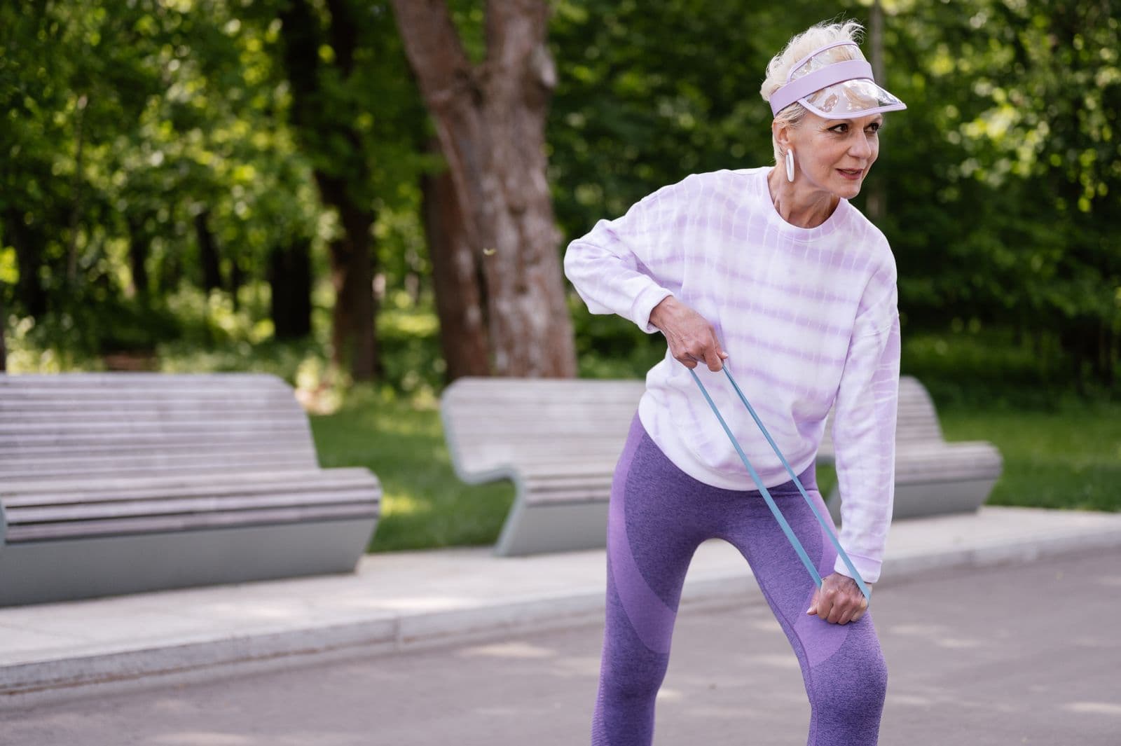 Older adult doing a balance and strength exercise with a resistance band
