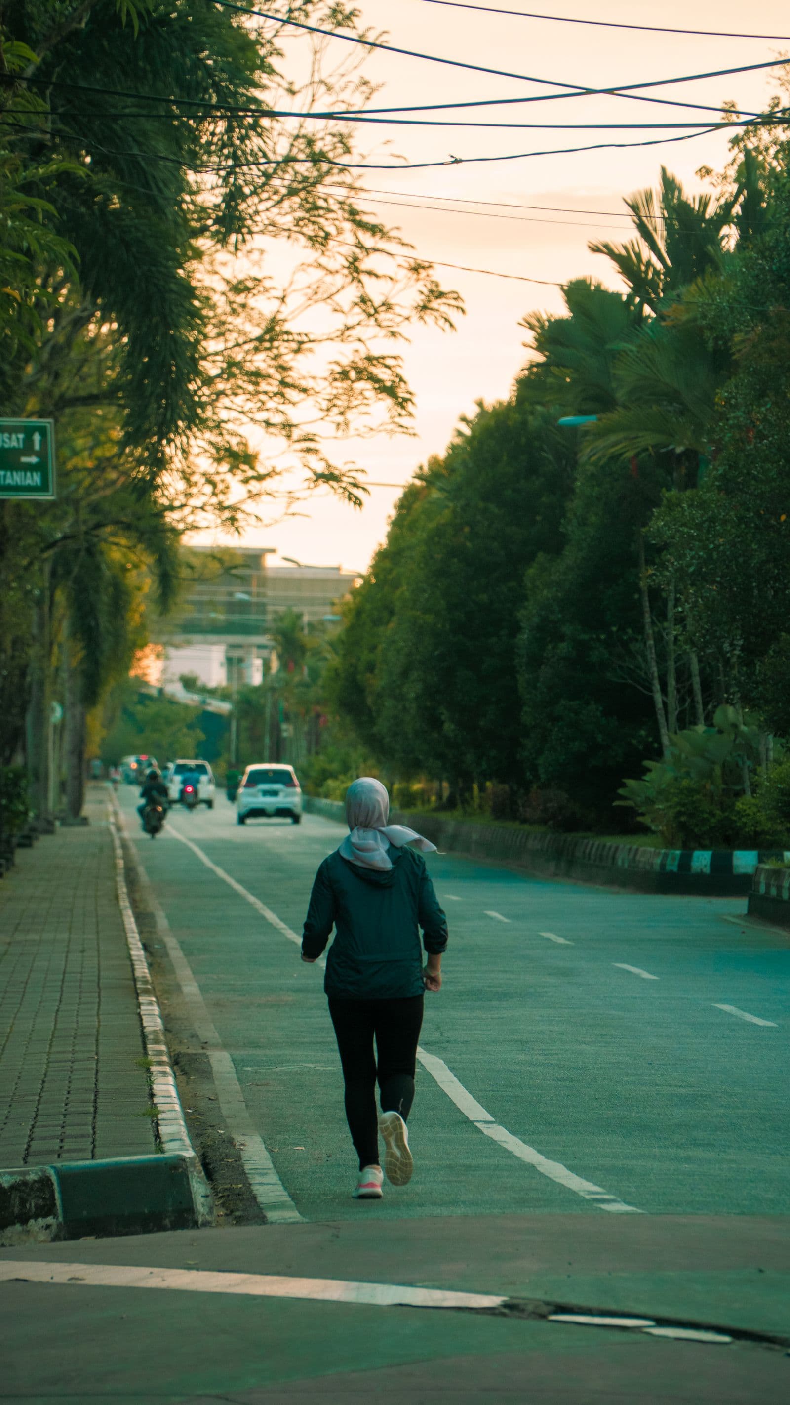 Runner jogging down a quiet street at an easy pace