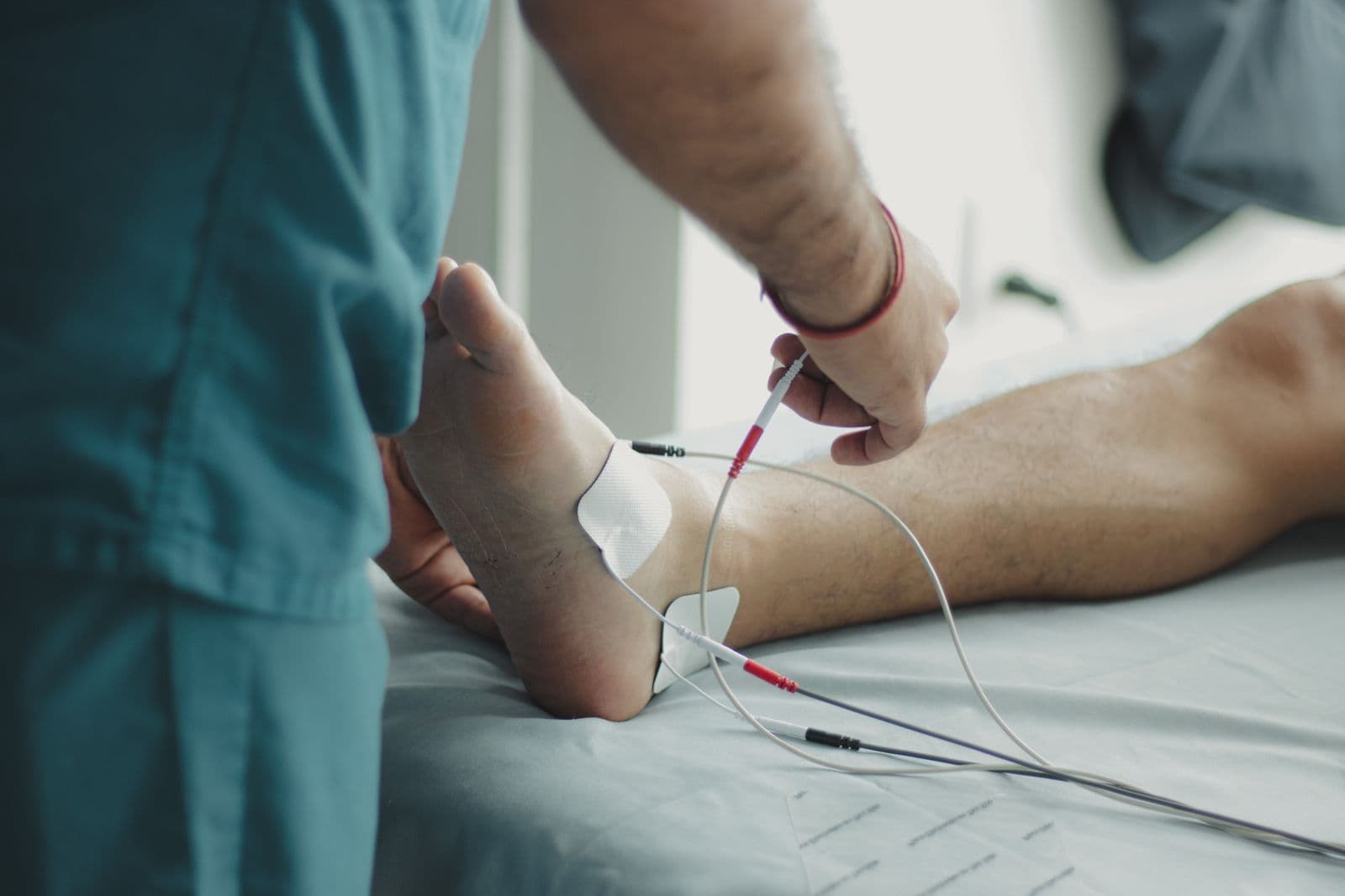 Clinician examining a patient's foot and lower leg
