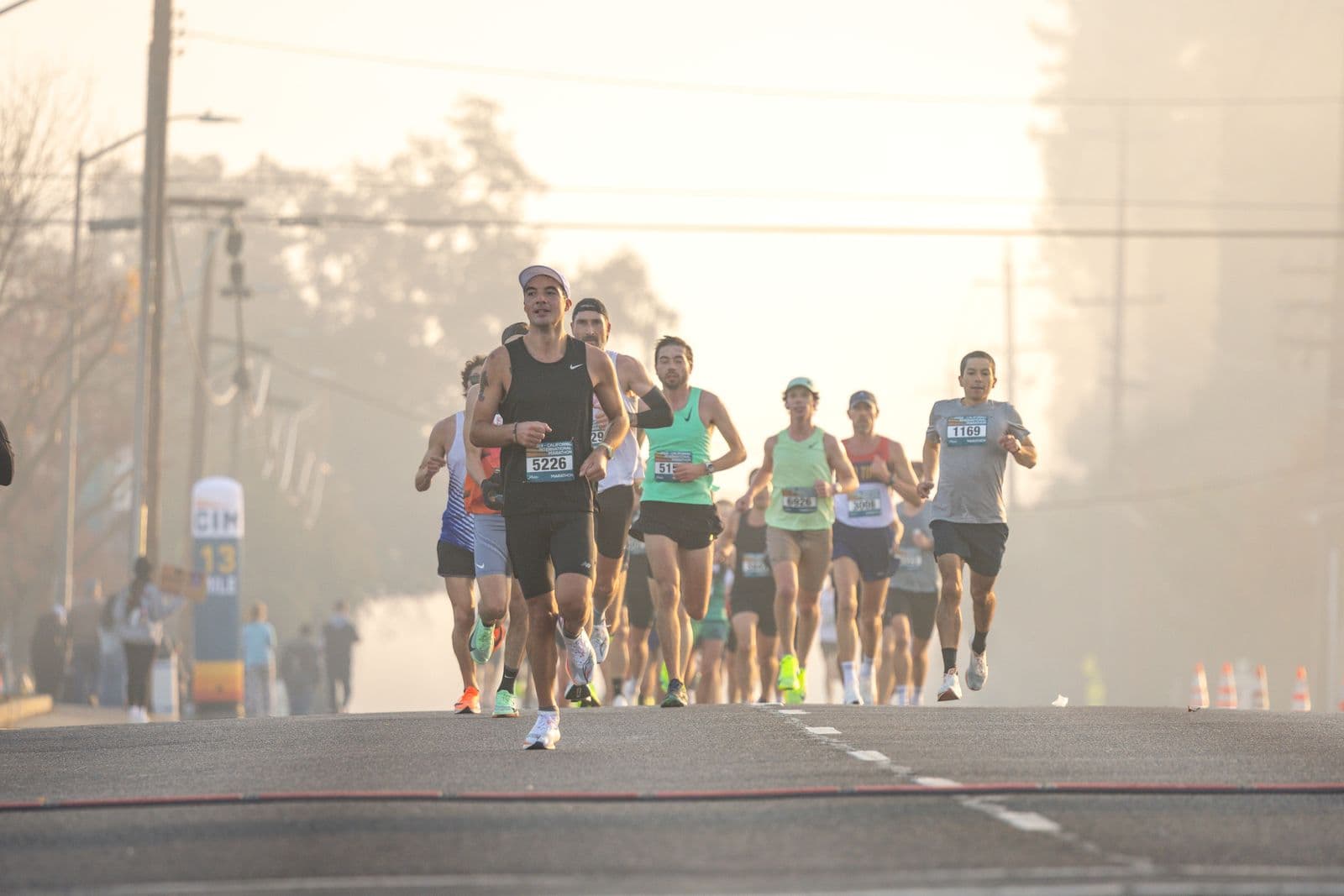 Marathon runners on a foggy morning street early in a race
