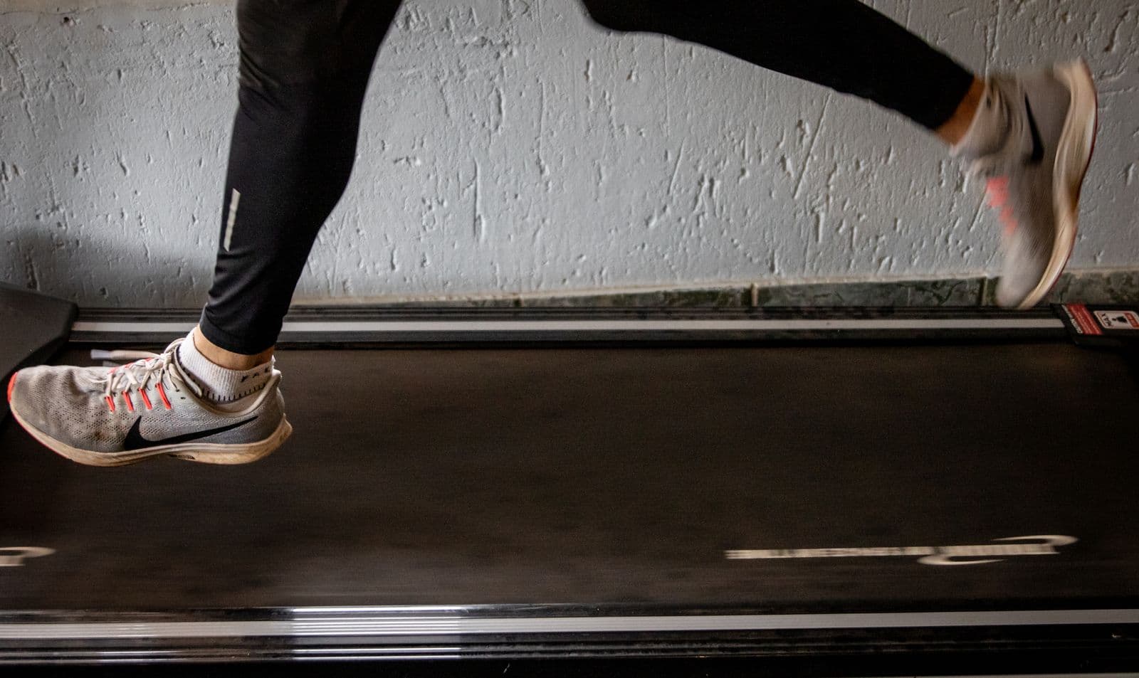 Runner's legs mid-stride on a treadmill, the setup used for a video gait analysis