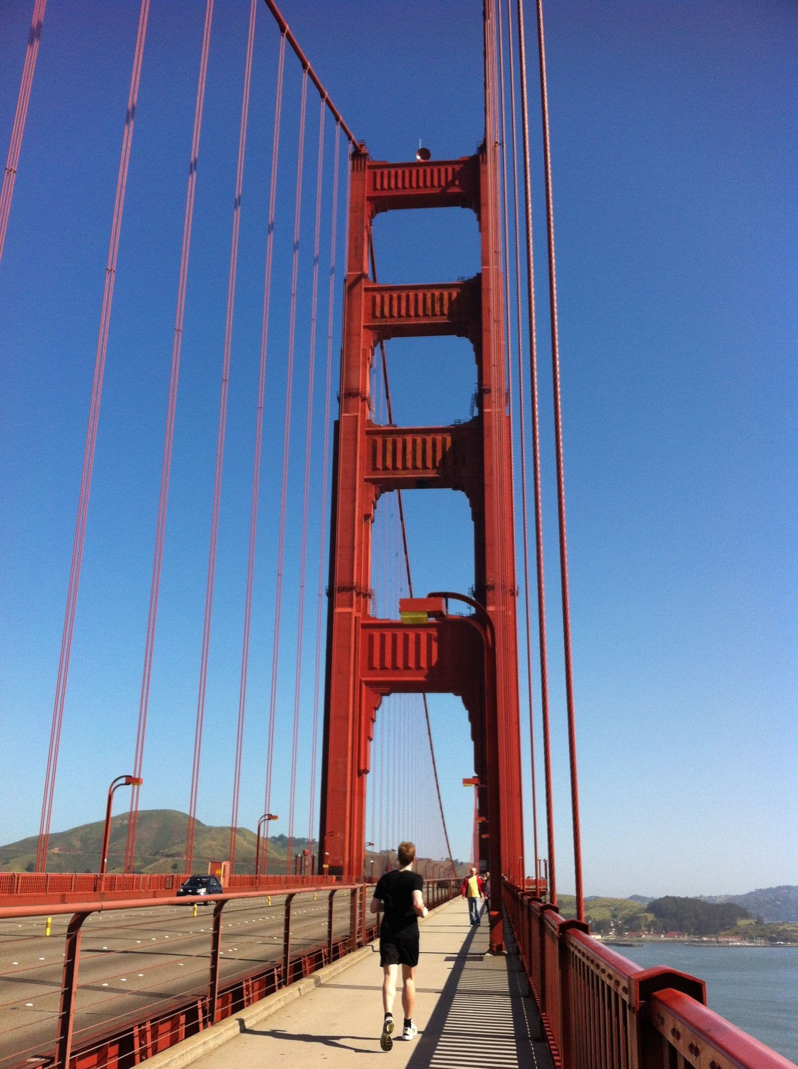 Jogger on the Golden Gate Bridge on a sunny day