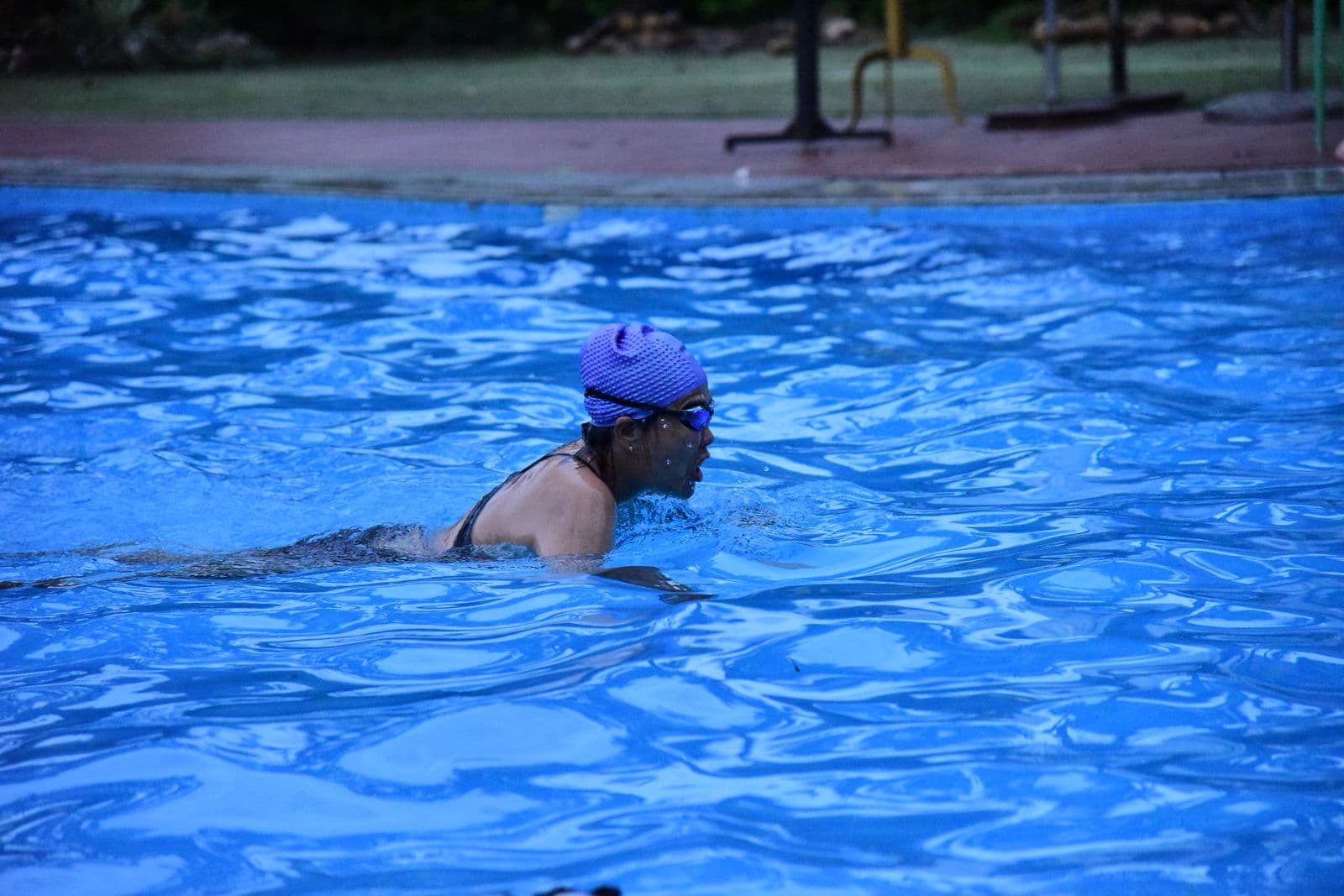 Swimmer doing laps in an outdoor pool