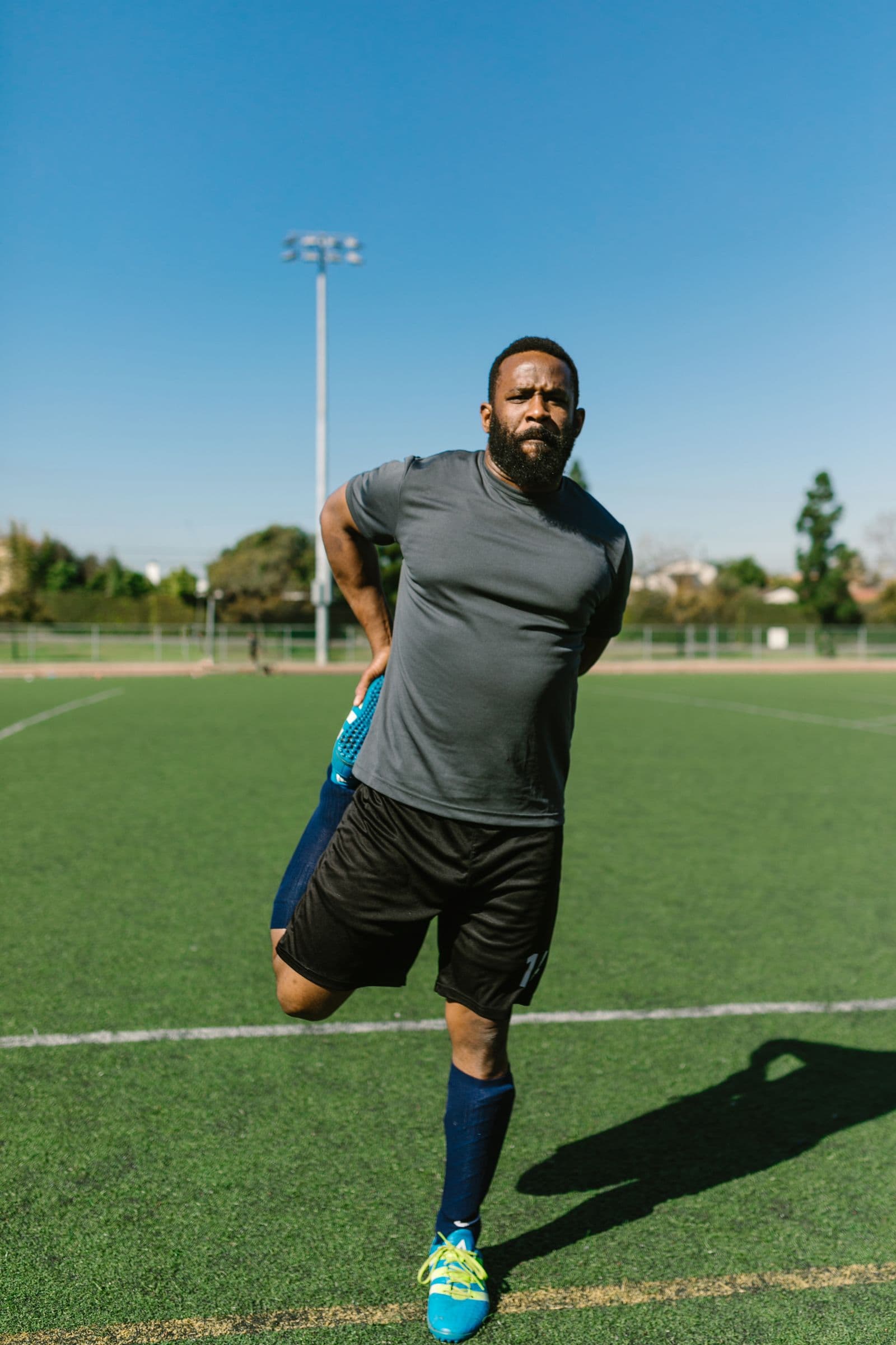 Player doing leg strength and mobility work on the field