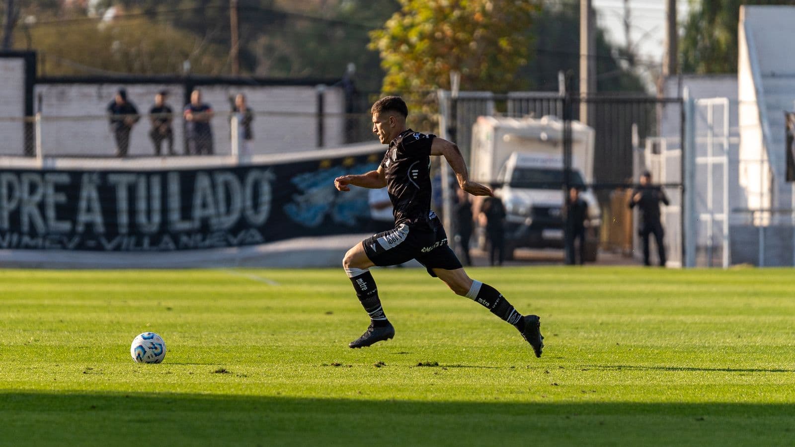 Soccer player planting and changing direction with the ball