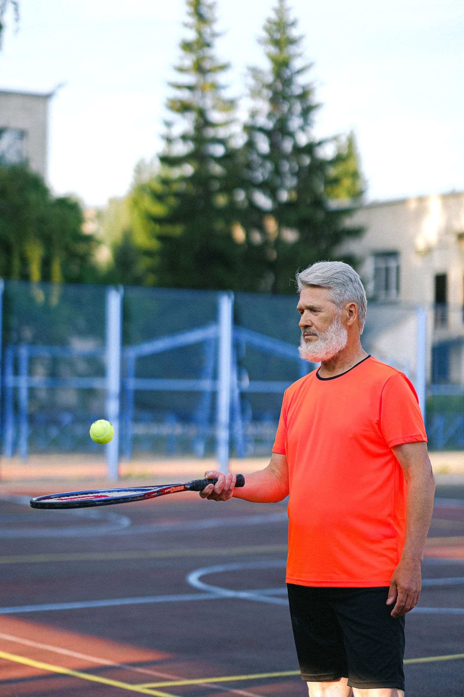Adult player practicing with a tennis ball on court