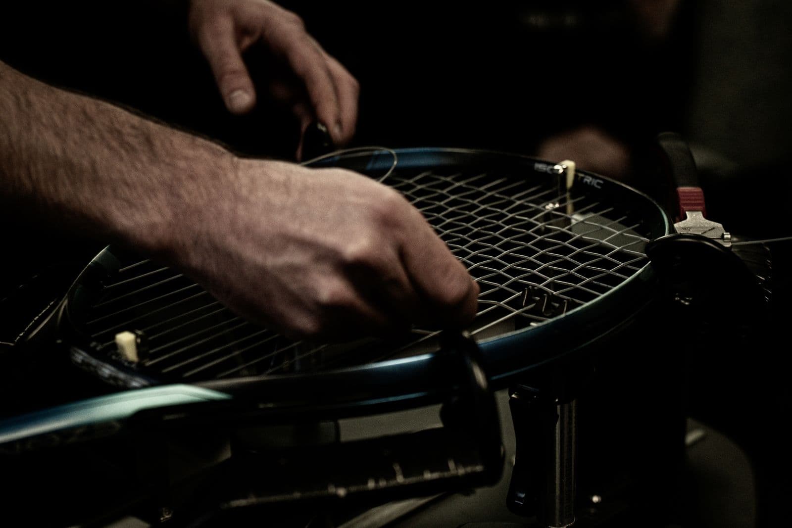 Close-up of a tennis racket being strung